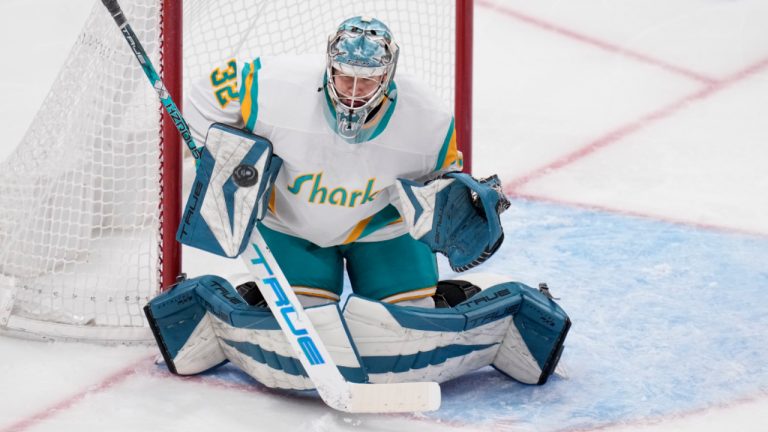 San Jose Sharks goaltender Eetu Makiniemi deflects a Vancouver Canucks shot during the third period of an NHL hockey game in San Jose, Calif., Wednesday, Dec. 7, 2022. Makiniemi made his NHL debut in the game. (Godofredo A. Vásquez/AP)