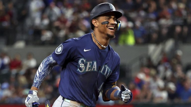 Seattle Mariners' Julio Rodriguez reacts toward the dugout as he runs the bases after hitting a two-run home run against the Texas Rangers. (Richard W. Rodriguez/AP)