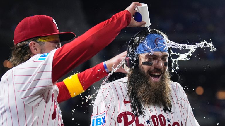 Philadelphia Phillies' Brandon Marsh, right, is doused by Bryson Stott after the Phillies won a baseball game against the Chicago Cubs, Wednesday, Sept. 25, 2024, in Philadelphia. (Matt Slocum/AP)