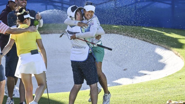 Jasmine Suwannapura, of Thailand, celebrates with her caddie and husband Mike Thomas after winning the LPGA Walmart NW Arkansas Championship golf tournament, Sunday, Sept. 29, 2024, in Rogers, Ark. (Michael Woods/AP Photo)
