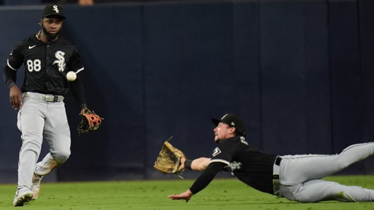 Chicago White Sox centre fielder Luis Robert Jr. (88) looks on as right fielder Dominic Fletcher can't reach a two-RBI double by San Diego Padres' Jackson Merrill during the sixth inning of a baseball game Friday, Sept. 20, 2024, in San Diego. (Gregory Bull/AP)