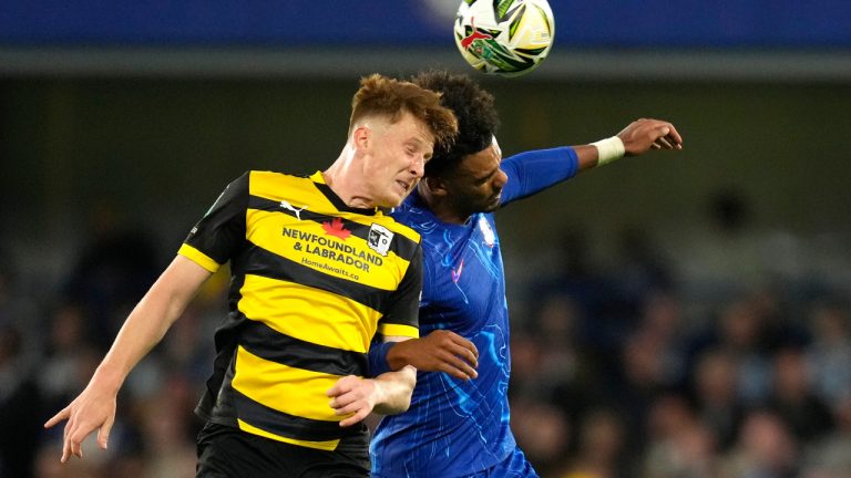Barrow's Ged Garner, left, challenges for the ball with Chelsea's Renato Veiga during the English League Cup third round soccer match between Chelsea and Barrow at Stamford Bridge stadium in London, Tuesday, Sept. 24, 2024. (Kirsty Wigglesworth/AP)