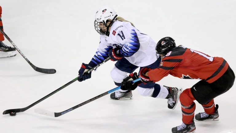 Team Canada's Brianne Jenner tries to steal the puck from Team USA's Brianna Decker during second period action of the Rivalry Series at the Save-On-Foods Memorial Centre in Victoria, B.C., on Monday, February 3, 2020. (Chad Hipolito/CP)