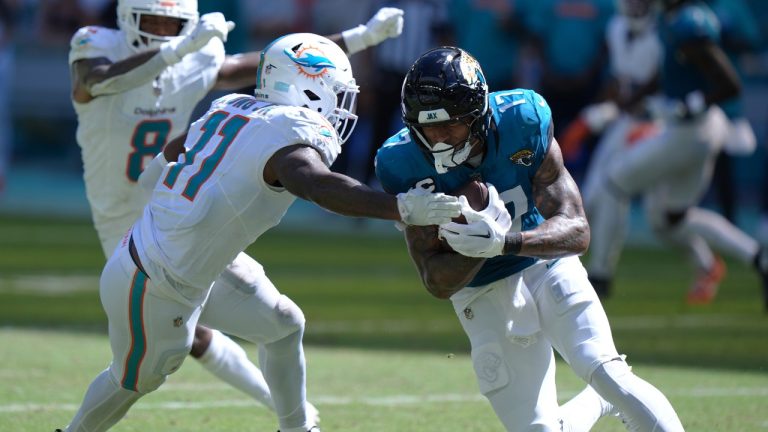 Jacksonville Jaguars tight end Evan Engram (17) runs with the football as Miami Dolphins linebacker David Long Jr. (11) attempts to stop him during the second half of an NFL football game, Sunday, Sept. 8, 2024, in Miami Gardens, Fla. (Wilfredo Lee/AP)