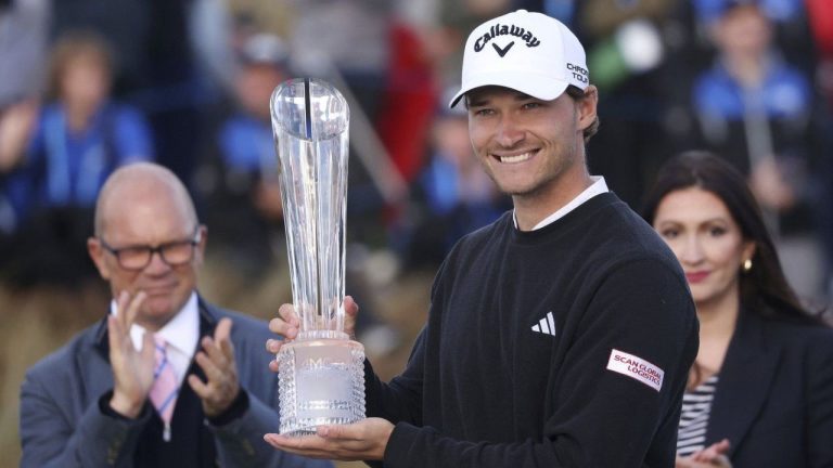 Denmark's Rasmus Hojgaard celebrates with the trophy after winning the Amgen Irish Open 2024 at Royal County Down in Newcastle, County Down, England, Sunday Sept. 15, 2024. (Peter Morrison/PA via AP)
