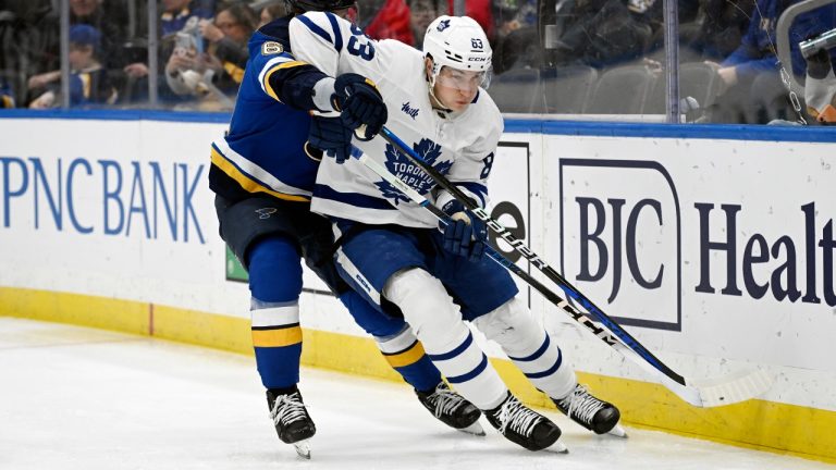 Toronto Maple Leafs defenceman Marshall Rifai works the puck against St. Louis Blues forward Jake Neighbours during the second period of an NHL game. (Michael Thomas/AP)