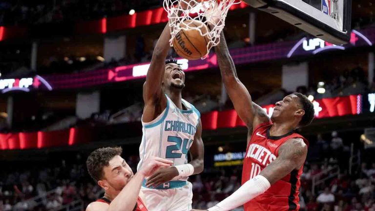 Charlotte Hornets forward Brandon Miller (24) dunks as Houston Rockets centre Alperen Sengun, left, and forward Jabari Smith Jr. defend during the first half of an NBA basketball game Wednesday, Oct. 23, 2024, in Houston. (Eric Christian Smith/AP)