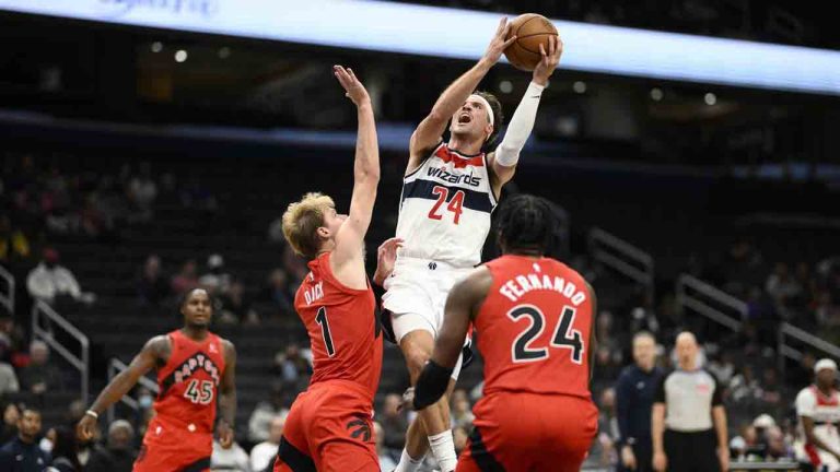 Washington Wizards forward Corey Kispert (24) goes to the basket against Toronto Raptors guard Gradey Dick (1) and forward Bruno Fernando (24) during the second half of an NBA pre-season basketball game, Friday, Oct. 11, 2024, in Washington. (Nick Wass/AP)