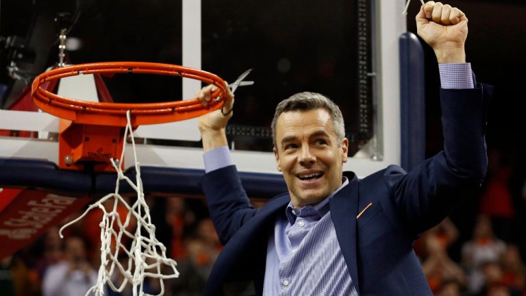 Virginia head coach Tony Bennett holds a piece of the net after a victory over Louisville after an NCAA college basketball game in Charlottesville, Va., Saturday, March 9, 2019. (Steve Helber/AP Photo)