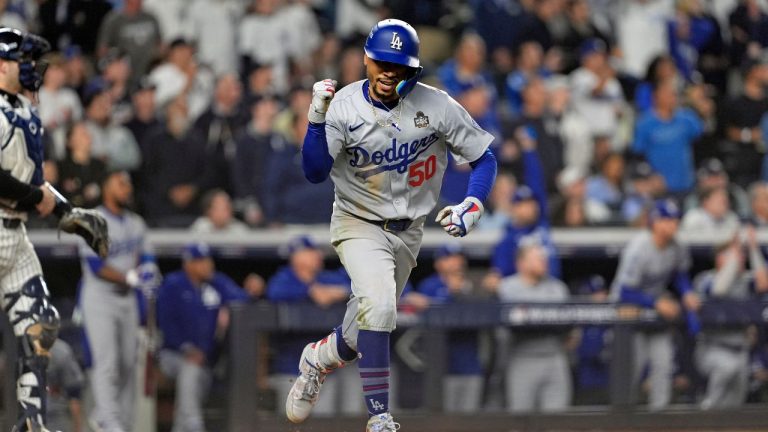 Los Angeles Dodgers' Mookie Betts (50) celebrates after hitting a sacrifice fly against the New York Yankees during the eighth inning in Game 5 of the baseball World Series, Wednesday, Oct. 30, 2024, in New York. (Godofredo A. Vásquez/AP Photo)