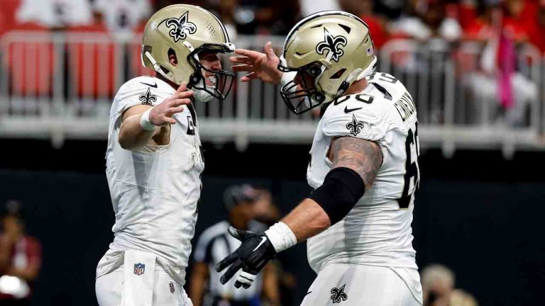 New Orleans Saints tight end Taysom Hill, left, celebrates his touchdown with center Shane Lemieux (66) in the end zone for a touchdown against the Atlanta Falcons during the first half of an NFL football game, Sunday, Sept. 29, 2024, in Atlanta. (Butch Dill/AP)