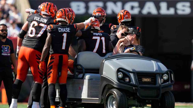 Cincinnati Bengals players approach offensive tackle Amarius Mims as he is carted off the field during the second half of an NFL football game against the Baltimore Ravens, Sunday, Oct. 6, 2024, in Cincinnati. (Carolyn Kaster/AP)