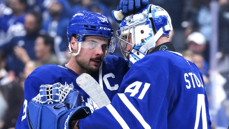 Toronto Maple Leafs' Auston Matthews, left, congratulates goaltender Anthony Stolarz after their team's victory over the Pittsburgh Penguins in NHL hockey action in Toronto, on Saturday, October 12, 2024.THE CANADIAN PRESS/Chris Young 