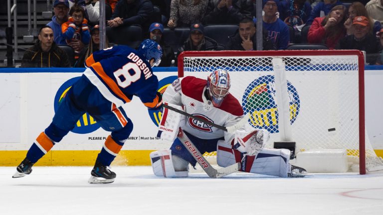 New York Islanders defenceman Noah Dobson (8) gets the winning goal against Montreal Canadiens goaltender Cayden Primeau (30) during the ninth round of shootout of an NHL hockey game, Saturday, Oct. 19, 2024, in Elmont, N.Y. (Michelle Farsi/AP)