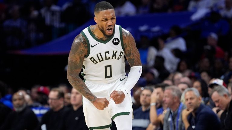 Milwaukee Bucks' Damian Lillard reacts after making a basket during the second half of an NBA basketball game. (Matt Slocum/AP)