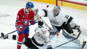 Montreal Canadiens' Oliver Kapanen (91) knocks down Los Angeles Kings' Brandt Clarke (92) as goaltender David Rittich (31) makes a save during second period NHL hockey action Thursday, October 17, 2024 in Montreal. (Ryan Remiorz/CP)