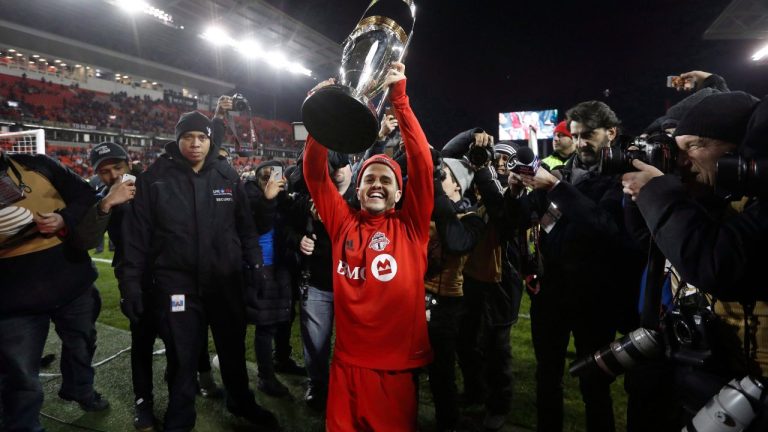 Toronto FC forward Sebastian Giovinco (10) hoists the trophy Toronto FC celebrate their win over the Seattle Sounders in the MLS Cup Final soccer action in Toronto on Saturday, December 9, 2017. (Mark Blinch/CP Photo)