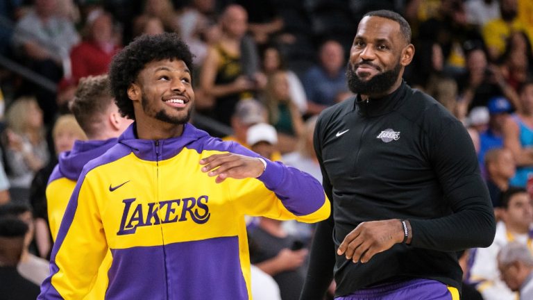 Los Angeles Lakers guard Bronny James, left, and forward LeBron James warm up before a preseason NBA basketball game against the Phoenix Suns, Sunday, Oct. 6, 2024, in Palm Desert, Calif. (William Liang/AP)