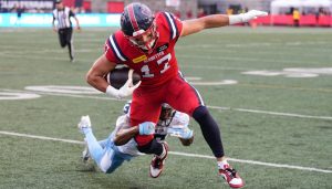Montreal Alouettes wide receiver Cole Spieker (17) is tackled by Toronto Argonauts defensive back Leonard Johnson (13) during first half CFL football action in Montreal, Thursday, July 11, 2024. (Christinne Muschi/CP)