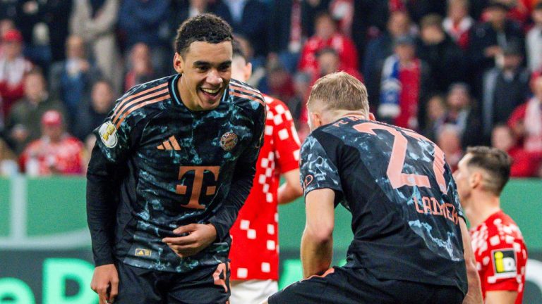 Bayern's Jamal Musiala, left, celebrates with Konrad Laimer after scoring a goal during a second round German Cup soccer match between FSV Mainz 05 and Bayern Munich, Wednesday, Oct. 30, 2024, in Mainz, Germany. (Torsten Silz/dpa via AP)