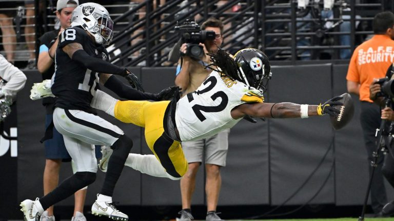 Pittsburgh Steelers running back Najee Harris (22) dives for the end zone to score past Las Vegas Raiders cornerback Jack Jones during the second half of an NFL football game in Las Vegas, Sunday, Oct. 13, 2024. (David Becker/AP Photo)
