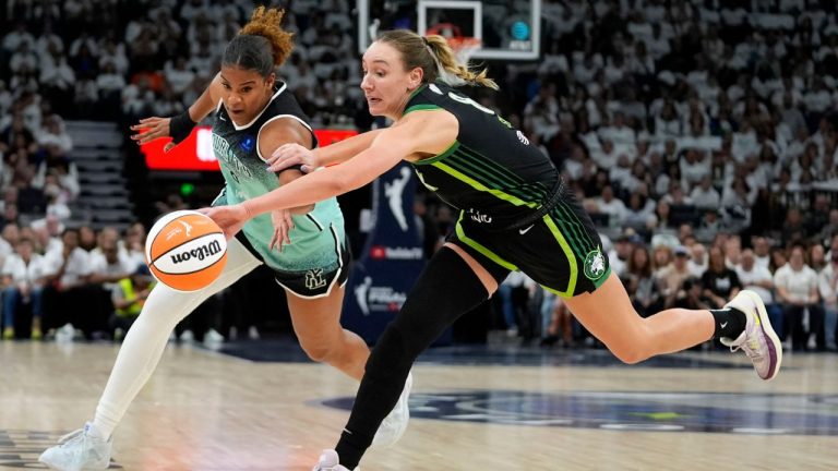New York Liberty forward Nyara Sabally, left, fights for a loose ball with Minnesota Lynx forward Alanna Smith during the first half in Game 3 of a WNBA basketball final playoff series, Wednesday, Oct. 16, 2024, in Minneapolis. (Abbie Parr/AP Photo)