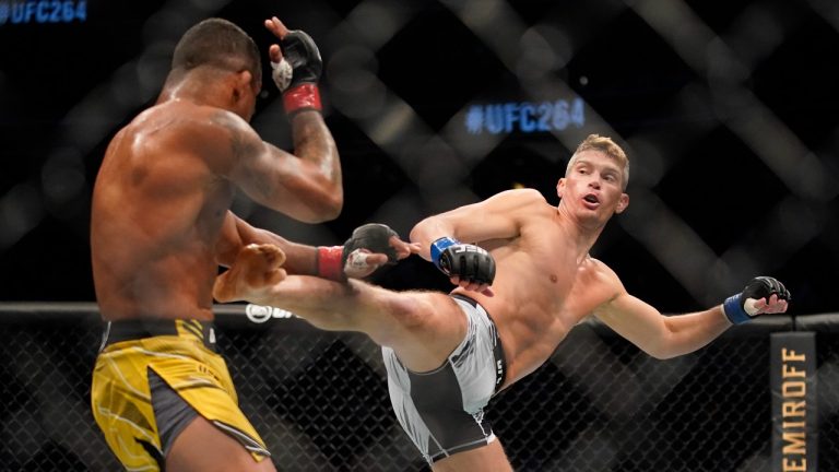 Stephen Thompson, right, kicks Gilbert Burns in a UFC 264 welterweight mixed martial arts bout Saturday, July 10, 2021, in Las Vegas. (AP Photo/John Locher)