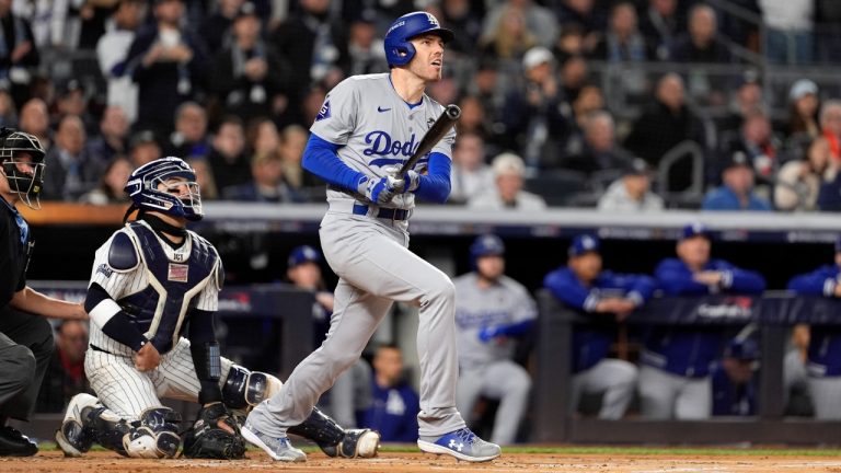Los Angeles Dodgers' Freddie Freeman, right, watches his two-run home run along with New York Yankees catcher Jose Trevino during the first inning in Game 3 of the baseball World Series, Monday, Oct. 28, 2024, in New York. (Godofredo A. Vásquez/AP)