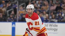 Flames’ Rooney helped off ice after hit from Canucks’ Miller