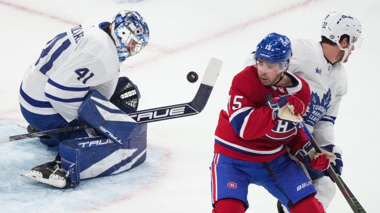 Toronto Maple Leafs goaltender Anthony Stolarz (41) stops a shot as Montreal Canadiens' Alex Newhook (15) and Leafs' Jake McCabe (22) look for the rebound during first period NHL hockey action in Montreal on Wednesday, Oct. 9, 2024. (Christinne Muschi/CP)
