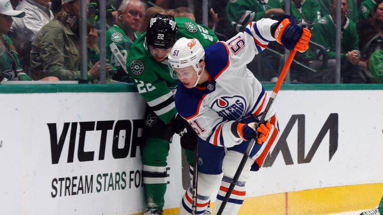 Dallas Stars left wing Jason Robertson (21) and Edmonton Oilers defenseman Troy Stecher (51) battle for the puck in the first period during an NHL hockey game on Saturday, Oct. 19, 2024, in Dallas. (Richard W. Rodriguez/AP)