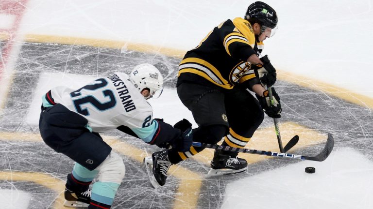 Seattle Kraken right wing Oliver Bjorkstrand, left, and Boston Bruins left wing Brad Marchand, right, chase the puck during the first period of an NHL hockey game, Sunday, Nov. 3, 2024, in Boston. (Mark Stockwell/AP)