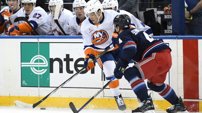 New York Islanders' Hudson Fasching, left, skates with the puck against New York Rangers' Braden Schneider, right, during the first period of an NHL hockey game, Sunday, Nov. 3, 2024, in New York. (Pamela Smith/AP) 