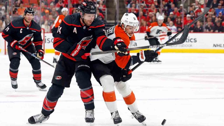 Carolina Hurricanes' Jaccob Slavin (74) battles Philadelphia Flyers' Travis Konecny (11) for the puck during the first period of an NHL hockey game in Raleigh, N.C., Tuesday, Nov. 5, 2024. (Karl B DeBlaker/AP)