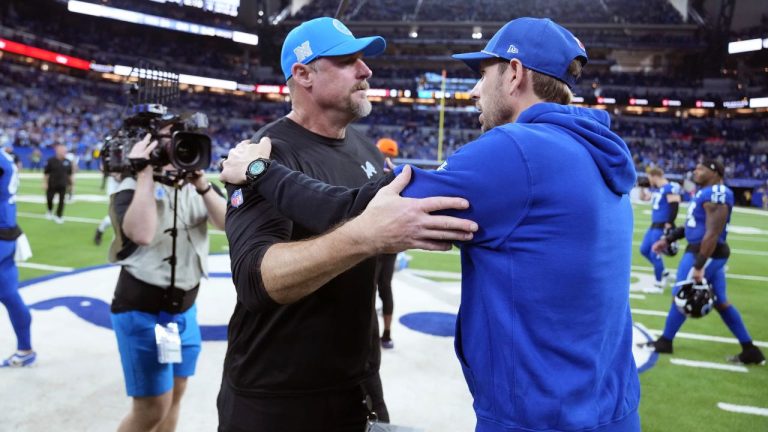 Detroit Lions head coach Dan Campbell, left, meets with Indianapolis Colts head coach Shane Steichen after an NFL game, Sunday, Nov. 24, 2024, in Indianapolis. (AP/Michael Conroy)