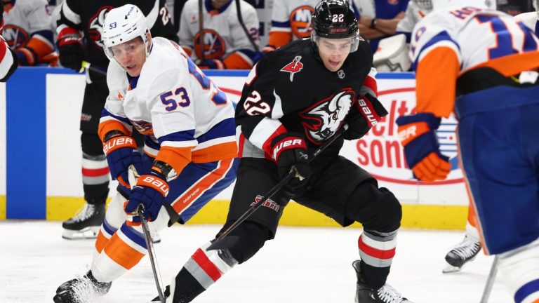 Buffalo Sabres right wing Jack Quinn (22) carries the puck past New York Islanders center Casey Cizikas (53) during the first period of an NHL hockey game Friday, Nov. 1, 2024, in Buffalo, N.Y. (AP Photo/Jeffrey T. Barnes)