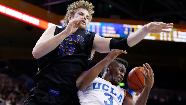 Morehead State's Chad Posthumus, left, fouls UCLA's Jordan Adams, right, on a rebound attempt during the first half of a Las Vegas Invitational regional NCAA college basketball game, Friday, Nov. 22, 2013, in Los Angeles.
Canadian basketball player Posthumus, a founding member of the Canadian Elite Basketball League, died Wednesday. He was 33. (Danny Moloshok/AP)