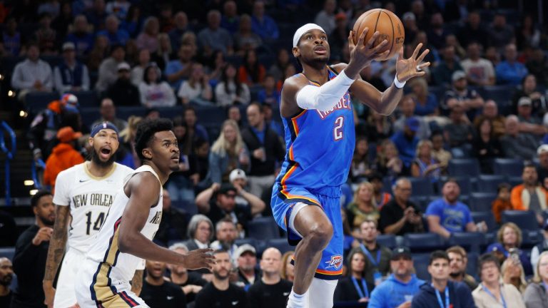 Oklahoma City Thunder guard Shai Gilgeous-Alexander (2) prepares to shoot in front of New Orleans Pelicans forward Brandon Ingram, left, and center Yves Missi, center, during the first half of an NBA basketball game Wednesday, Nov. 13, 2024, in Oklahoma City. (AP Photo/Nate Billings)
