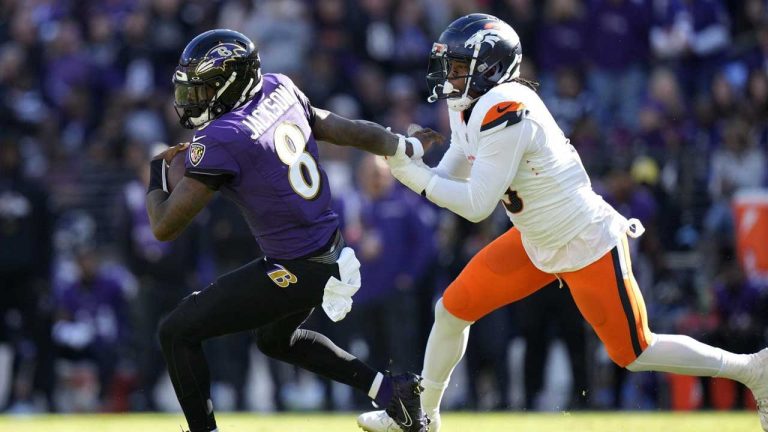 Baltimore Ravens quarterback Lamar Jackson, left, is pursued by Denver Broncos linebacker Baron Browning in the first half of an NFL football game. (Stephanie Scarbrough/AP)