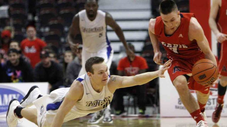 University of British Columbia Thunderbirds Doug Plumb (10) attempts to reach for the ball as Acadia University Axemen Sean Stoqua (7) drives down the court at the Canadian Interuniversity Sport Basketball final 8, in Ottawa, Friday, March 8, 2013. (Fred Chartrand/CP)