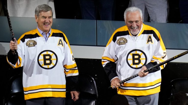 Boston Bruins greats Bobby Orr, left, and Phil Esposito laugh during a celebration of the 100th year of the team, prior to an NHL hockey game between the Bruins and Chicago Blackhawks, Wednesday, Oct. 11, 2023, in Boston. (Charles Krupa/AP Photo)