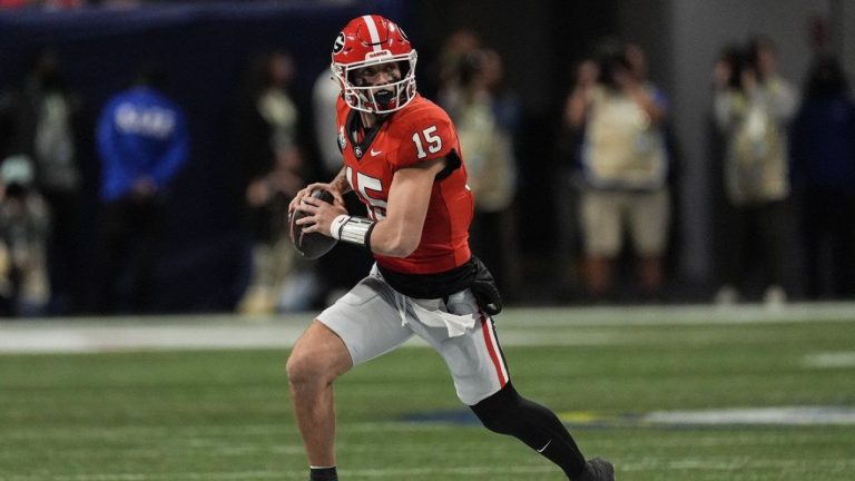 Georgia quarterback Carson Beck (15) runs out of the pocket against Texas during the first half of the Southeastern Conference championship NCAA college football game, Saturday, Dec. 7, 2024, in Atlanta. (John Bazemore/AP)