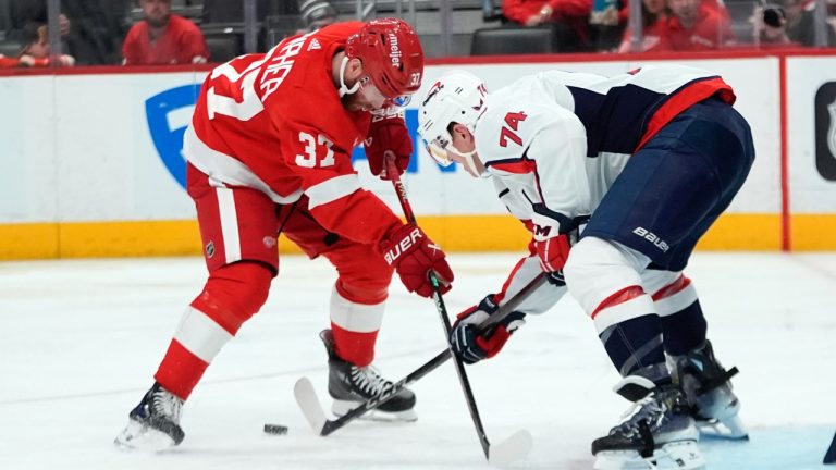 Detroit Red Wings left wing J.T. Compher (37) loses the puck to Washington Capitals defenseman John Carlson (74) in the second period of an NHL hockey game Tuesday, April 9, 2024, in Detroit. (Paul Sancya/AP)