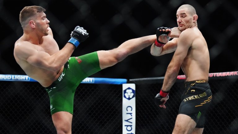 Sean Strickland, right, fights Dricus Du Plessis during a middleweight title bout at UFC 297 in Toronto on Sunday, January 21, 2024. (THE CANADIAN PRESS/Nathan Denette)