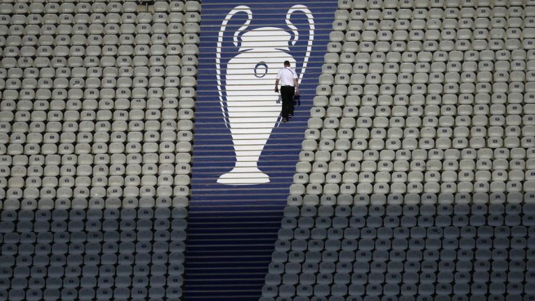 A security official walks past a Champions League trophy logo during an Inter Milan training session at the Ataturk Olympic Stadium in Istanbul, Turkey, Friday, June 9, 2023. (Thanassis Stavrakis/AP)