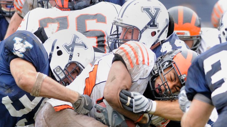 Princeton's Jordan Culbreath, center, fights for an extra yard as he is tackled by Yale's Jay Pilkerton, left, Bobby Abare, center, and Brady Hart, right during Yale's 14-0 victory in an NCAA college football game in New Haven, Conn., on Saturday, Nov. 15, 2008. (AP Photo/Fred Beckham, File)