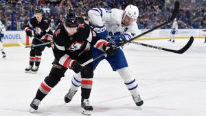 Buffalo Sabres defenceman Bowen Byram, left, challenges for the puck against Toronto Maple Leafs center John Tavares, right, during the first period of an NHL hockey game in Buffalo, N.Y., Friday, Dec. 20, 2024. (Adrian Kraus/AP)