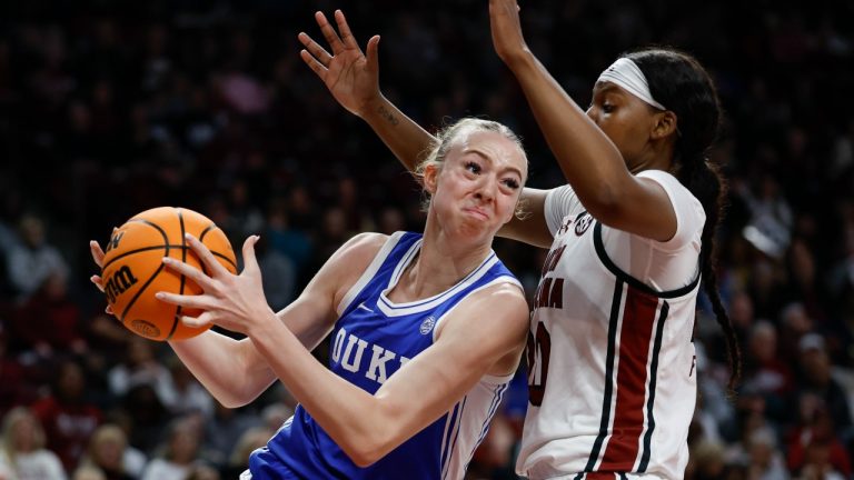 Duke forward Toby Fournier, left, drives into South Carolina forward Sania Feagin during the first half of an NCAA college basketball game in Columbia, S.C., Thursday, Dec. 5, 2024. (AP Photo/Nell Redmond)