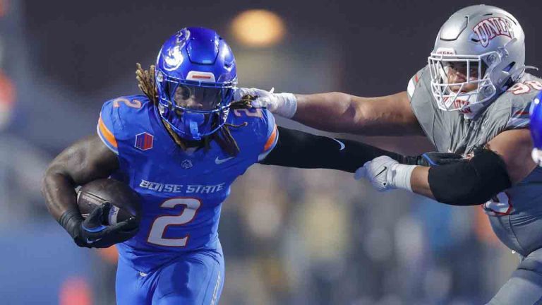Boise State running back Ashton Jeanty (2) pushes away from the arms of UNLV defensive lineman Tatuo Martinson (98) on a run in the first half of the Mountain West Championship NCAA college football game Friday, Dec. 6, 2024, in Boise, Idaho. (Steve Conner/AP)