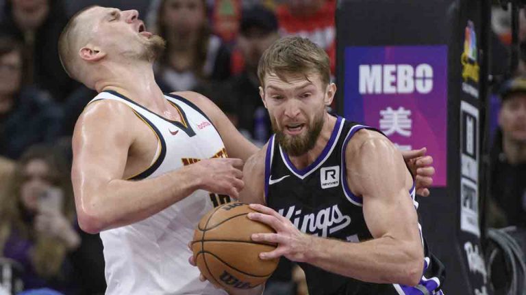 Denver Nuggets centre Nikola Jokic, left, and Sacramento Kings forward Domantas Sabonis, right, battle for the ball during the first half of an NBA basketball game in Sacramento, Calif., Monday, Dec. 16, 2024. (Randall Benton/AP)